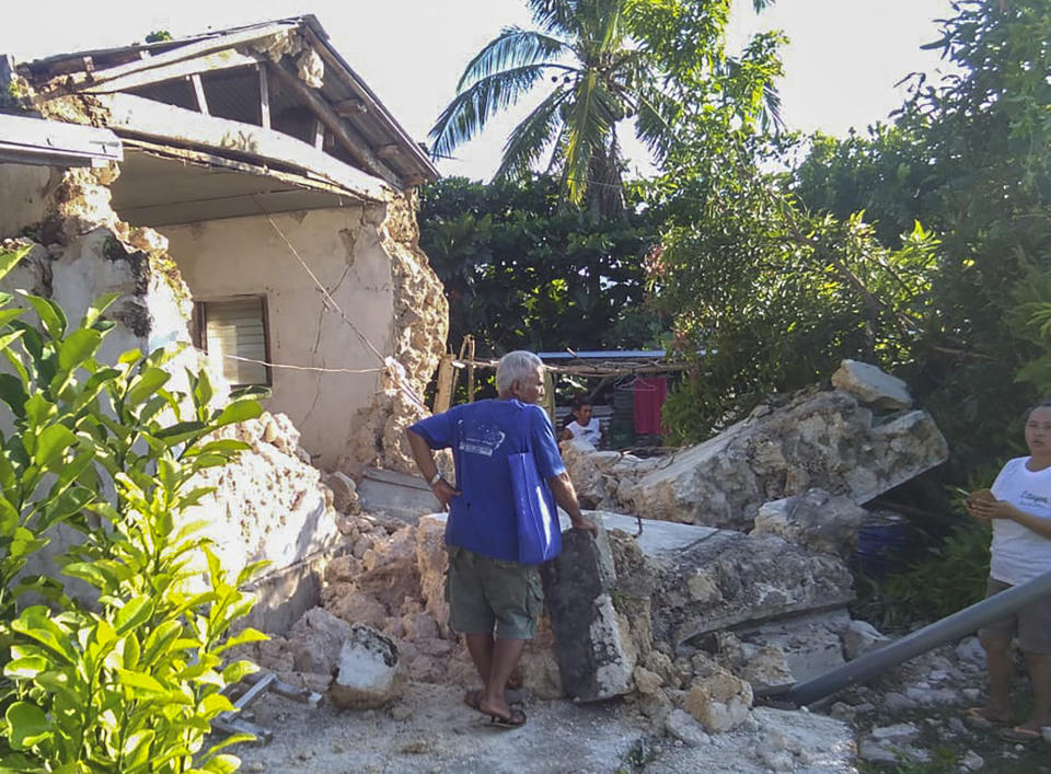 A resident looks at damaged houses in Itbayat town, Batanes islands, northern Philippines following the earthquakes Saturday, July 27, 2019. Two strong earthquakes hours apart struck a group of sparsely populated islands in the Luzon Strait in the northern Philippines early Saturday. (Agnes Salengua Nico via AP)