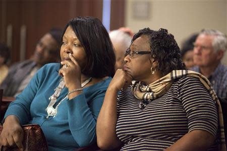 Stinney family relatives Mable Pratt (L) and her cousin Jannie Nelson, both of Columbia, South Carolina, listen during testimony in the case of George Stinney Jr., in Sumter, South Carolina, January 22, 2014. Judge Carmen T. Mullen ruled to give lawyers an additional 10 days to research the details of the case before she makes a ruling. Attorneys say the request for the 1944 trial so long after a defendant's death is the first of its kind in the state. George Stinney Jr., the youngest person to be executed in the United States in the past century, was convicted by an all-white jury in 1944 of killing the two girls, ages 7 and 11, in the small mill town of Alcolu, South Carolina. REUTERS/Randall Hill (UNITED STATES - Tags: CRIME LAW)