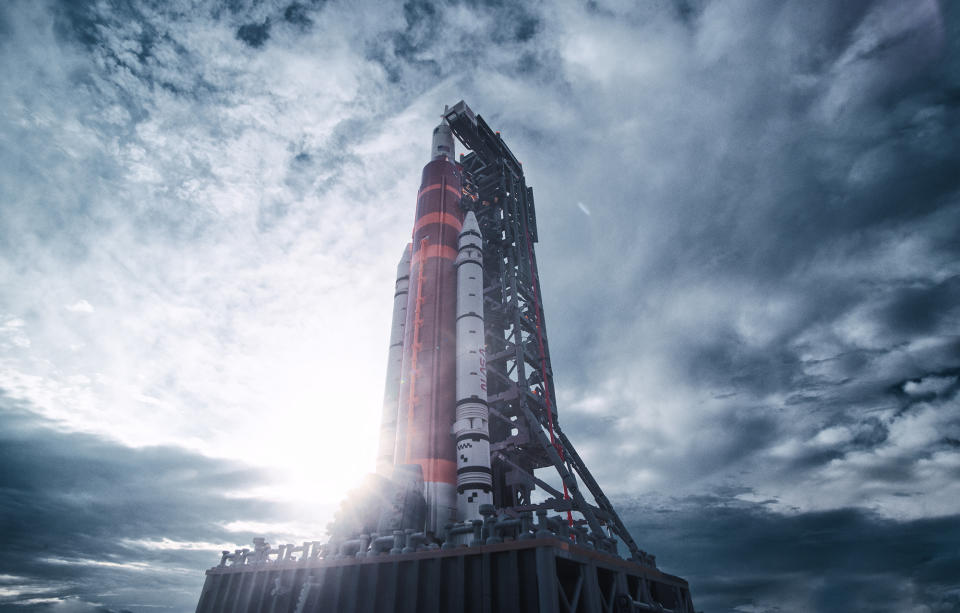 a rocket made of plastic bricks under a cloudy blue sky