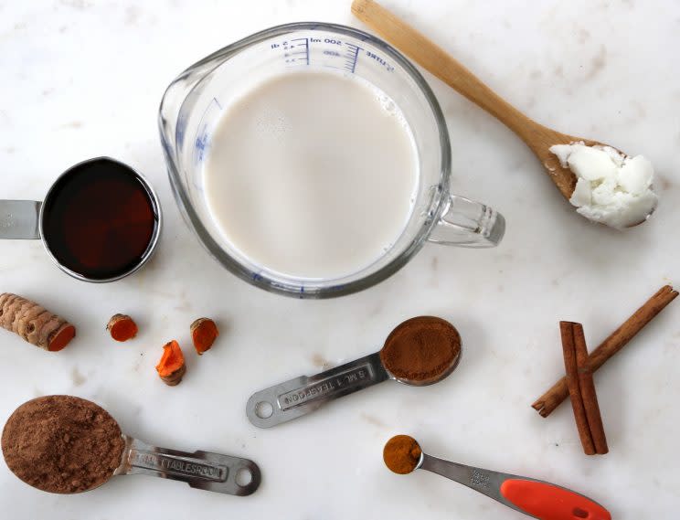 Milk, cacao powder, and other ingredients for turmeric hot chocolate 
