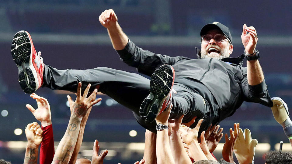 Jurgen Klopp is hoisted up by his victorious Liverpool squad. 