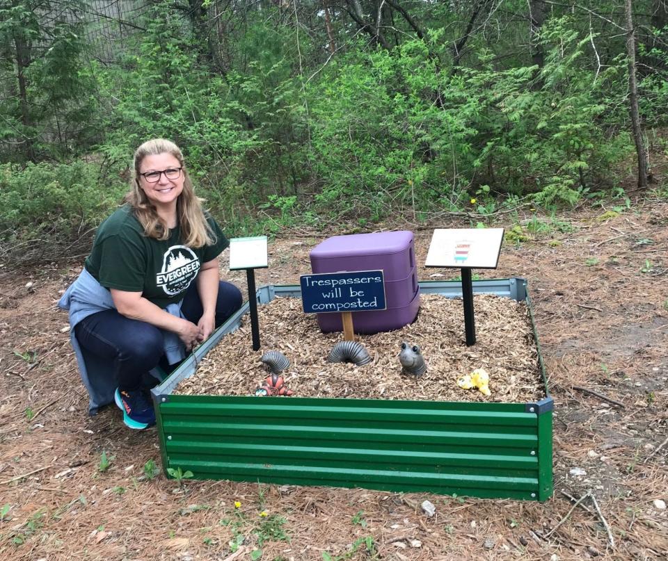 Kerry Johnson, owner of Evergreen Miniature Golf in Fish Creek, checks out the compost garden on the eco-themed course, which features fun environmental displays and signs.