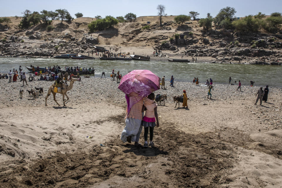 Refugiados que escaparon de la región de Tigray, en Etiopía, llegan Hamadyet, localidad sudanesa al borde del río Tekenze, el 21 de noviembre del 2020. Testigos dicen que hay fuerzas eritreas que cometen matanzas y saqueos en Tigray. (AP Photo/Nariman El-Mofty, File)