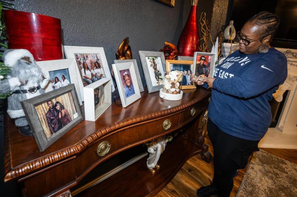 LaKeisha Mackey, the co-founder of Mothers of Murdered Angels, holds her favorite picture of her son Derrick Johnson at her home in Fort Worth on Friday, Dec. 1, 2023. Mackey’s son Derrick, 19, was killed in a shooting in 2020. Along with her son, she also lost her uncle in 1980, her father in 1989 and her sister in 2017, all to gun violence.
