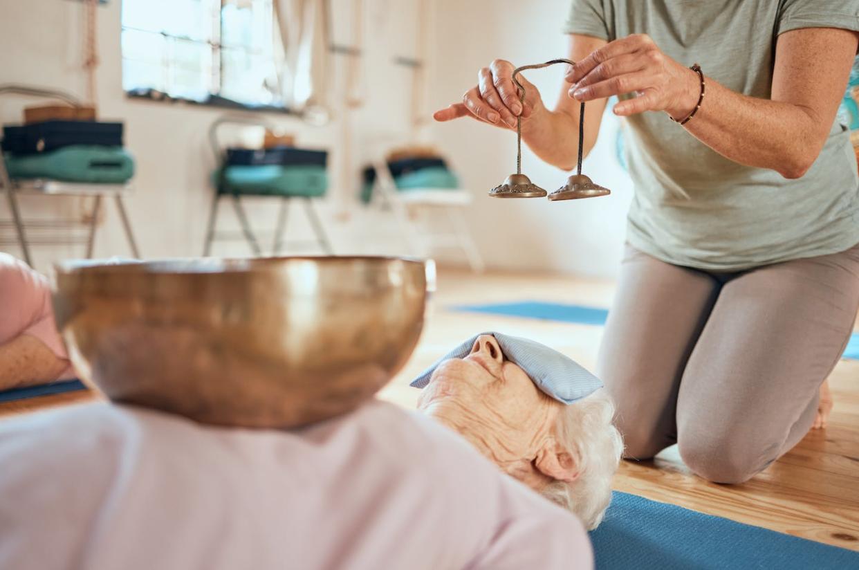 Sound therapy, which uses bells and singing bowls for healing, has gained popularity in recent years. <a href="https://www.gettyimages.com/detail/photo/sound-bell-healing-and-senior-woman-giving-royalty-free-image/1459154522?phrase=sound+bath&adppopup=true" rel="nofollow noopener" target="_blank" data-ylk="slk:PeopleImages/iStock via Getty Images plus;elm:context_link;itc:0;sec:content-canvas" class="link ">PeopleImages/iStock via Getty Images plus</a>