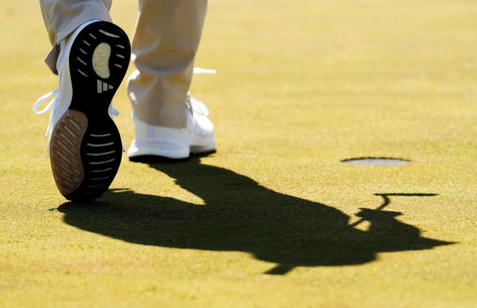 Eileen Chon from Irvine, Calif., steps past the no. 18 hole during the Drive, Chip & Putt National Finals competition at Augusta National Golf Club.