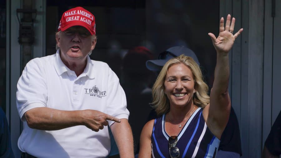 <em>Greene waves while Trump points to her as they look over the 16th tee during a LIV Golf tournament in Bedminster, N.J., on July 30, 2022. (AP Photo/Seth Wenig, File)</em>