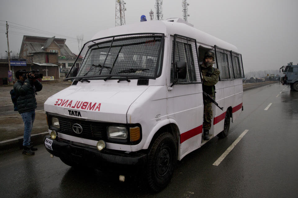 An Indian paramilitary soldier accompanies the ambulance carrying injured colleagues near the site of an explosion in Pampore, Indian-controlled Kashmir, Thursday, Feb. 14, 2019. Security officials say at least 10 soldiers have been killed and 20 others wounded by a large explosion that struck a paramilitary convoy on a key highway on the outskirts of the disputed region's main city of Srinagar. (AP Photo/Dar Yasin)