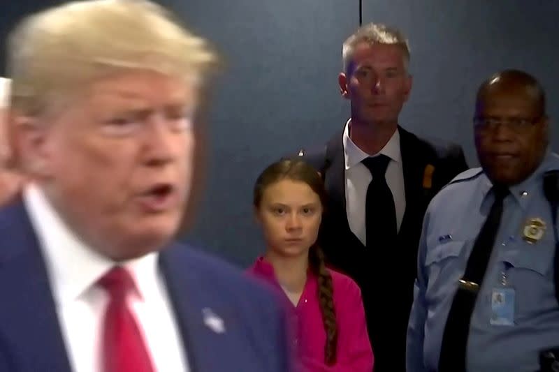 FILE PHOTO: Swedish environmental activist Greta Thunberg watches as U.S. President Donald Trump enters the United Nations