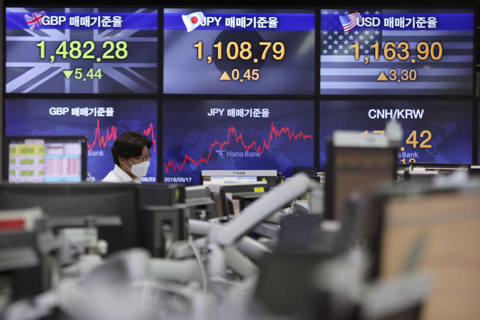 A currency trader watches monitors at the foreign exchange dealing room of the KEB Hana Bank headquarters in Seoul, South Korea, Wednesday, Sept. 23, 2020. Asian markets were mostly lower on Wednesday as investors kept a wary eye on how the coronavirus pandemic will affect the economic outlook.(AP Photo/Ahn Young-joon)