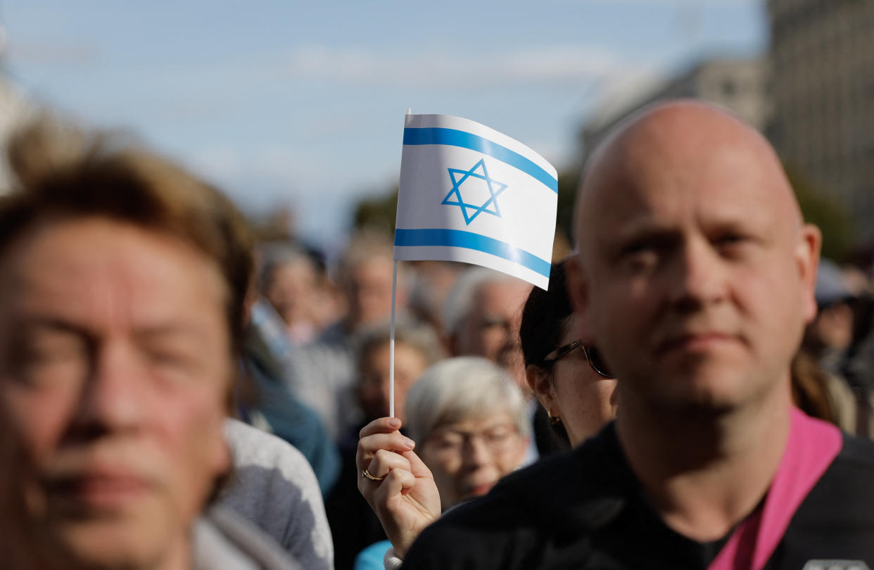 A woman waves an Israeli flag during a demonstration in support of Israel called by Jewish organizations, on October 8, 2023 in front of landmark Brandenburg Gate in Berlin.