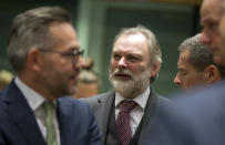 Britain's Ambassador to the EU Sir Tim Barrow, center, waits for the start of a meeting of EU Europe Affairs ministers at the Europa building in Brussels, Tuesday, Dec. 11, 2018. Top European Union officials ruled out Tuesday any renegotiation of the divorce agreement with Britain as Prime Minister Theresa May launched her fight to save her Brexit deal by lobbying leaders in Europe's capitals. (AP Photo/Virginia Mayo)