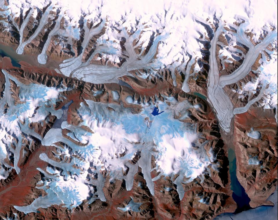 Ellesmere Island is part of the Qikiqtaaluk Region of the Canadian territory of Nunavut with the most northerly point of land in Canada. Inhabited since about 2000 BC, its current population is less than 200. Large portions of Ellesmere Island are covered with glaciers and ice, as seen in this image of a portion of the north-central part of the island.