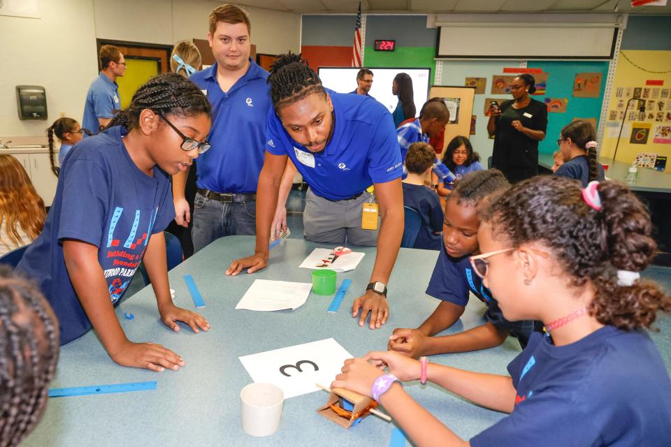 Florida Power and Light Company employees helped Lakewood Park Elementary fifth grade students compete in a generator build competition during their STEM classroom makeover reveal.