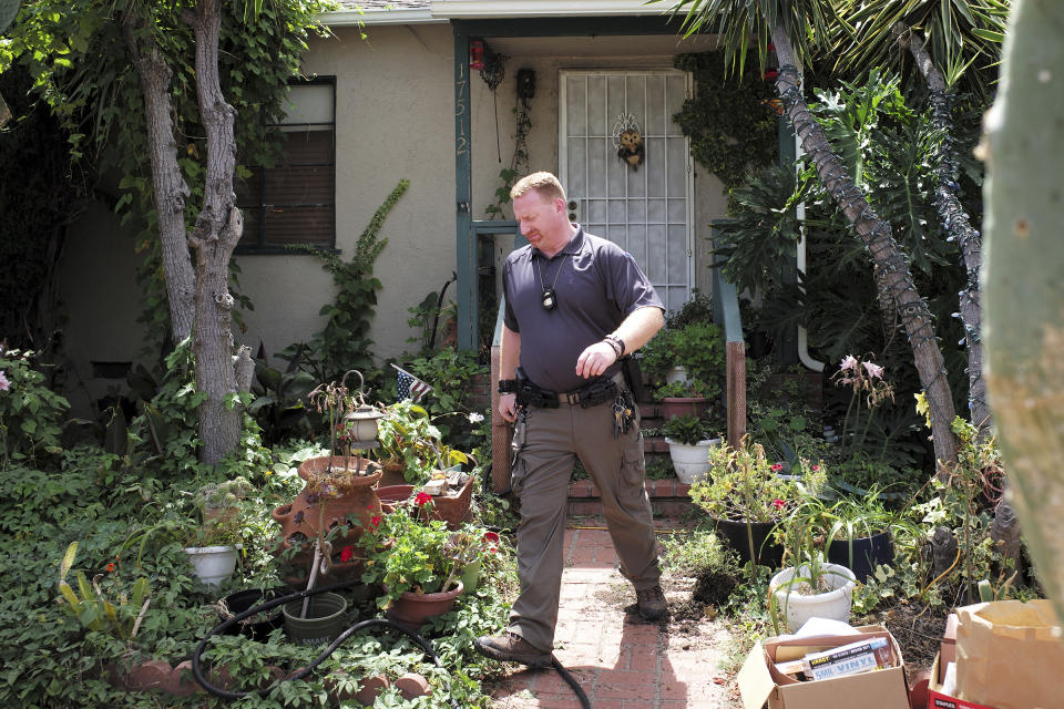 An FBI agent leaves the home of Robert Chain in the Encino section of Los Angeles on Thursday, Aug. 30, 2018. Chain who was upset about The Boston Globe's coordinated editorial response to President Donald Trump's attacks on the news media, was arrested Thursday for threatening to travel to the newspaper's offices and kill journalists, whom he called the "enemy of the people," federal prosecutors said. (David Crane/Los Angeles Daily News via AP)