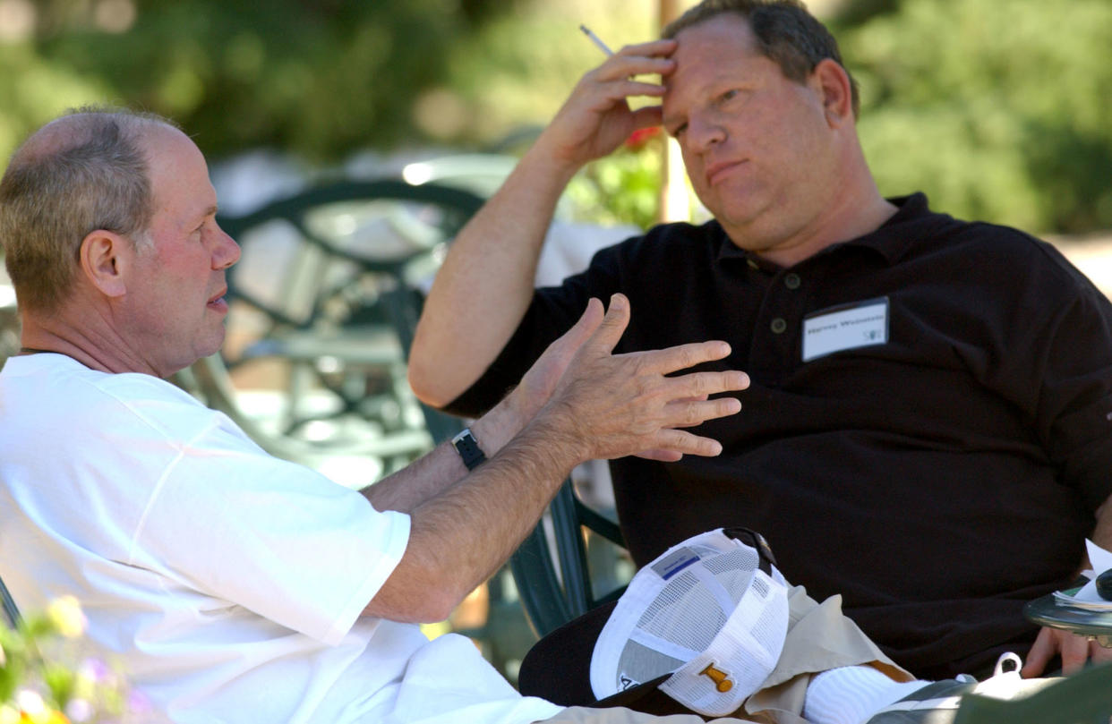 Michael Eisner, then CEO of the Walt Disney Company, talks with Harvey Weinstein&nbsp;back in 2004. (Photo: Bloomberg via Getty Images)