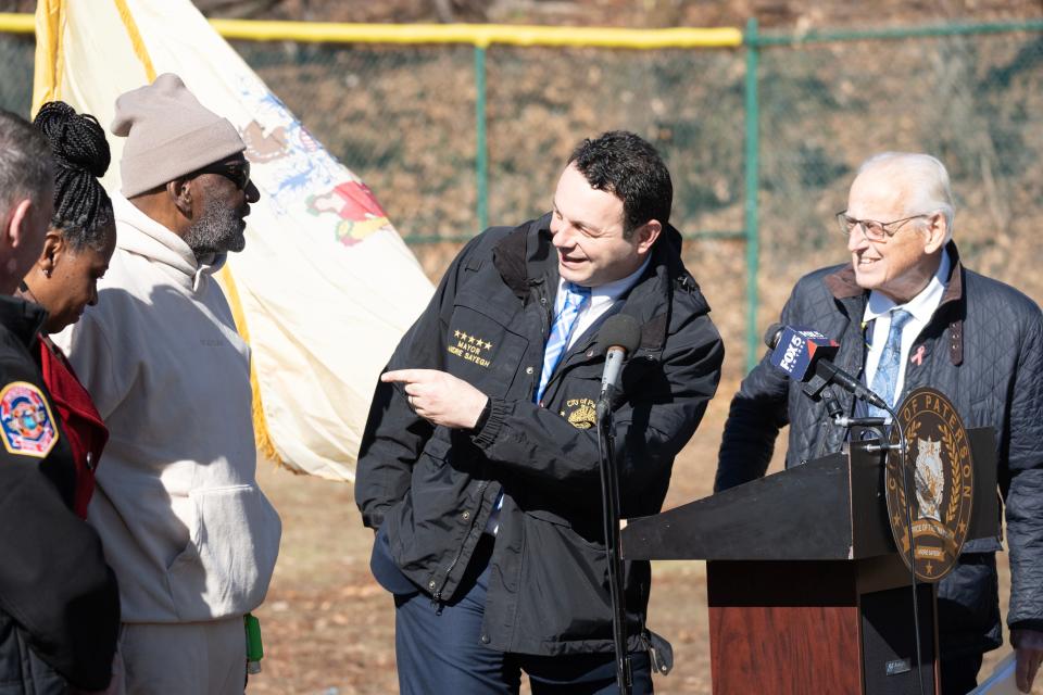 Center, Paterson Mayor Andre Sayegh points to John Briggs as Congressman Pascrell looks on. US Congressman Bill Pascrell, Jr presented a novelty check of $1,000,000 for the restoration of John Briggs Athletic Field at West Side Park in Paterson, NJ on Monday Feb. 13, 2023. The money will be used to provide a turf field, new lights and bleachers for the field named after Paterson native John Briggs who played professional baseball for the Phillies and other teams during his career. 