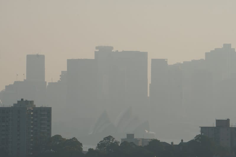 The Sydney Opera House is seen through smoke from bushfires in Sydney