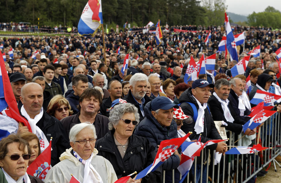 Mourners from Croatia attend a liturgiccal service for victims of the end of WWII events in Bleiburg, southern Austria, Saturday, May 18, 2019. Thousands of Croatian far-right supporters have gathered in a field in southern Austria to commemorate the massacre of pro-Nazi Croats by communists at the end of World War II. (AP Photo/Darko Bandic)