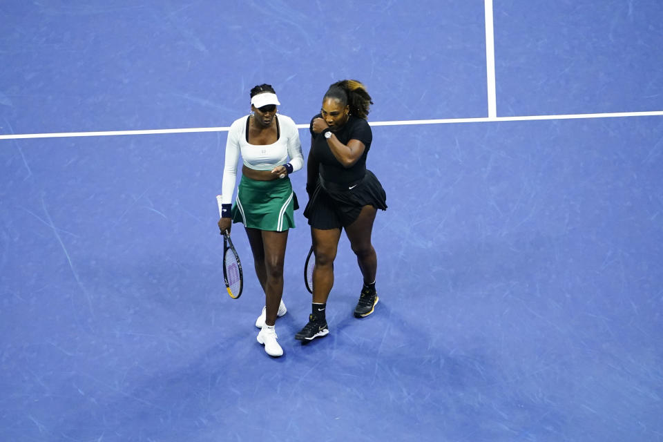 Serena Williams, right, and Venus Williams, of the United States, meet during their first-round doubles match against Lucie Hradecká and Linda Nosková, of the Czech Republic, at the U.S. Open tennis championships, Thursday, Sept. 1, 2022, in New York. (AP Photo/Frank Franklin II)