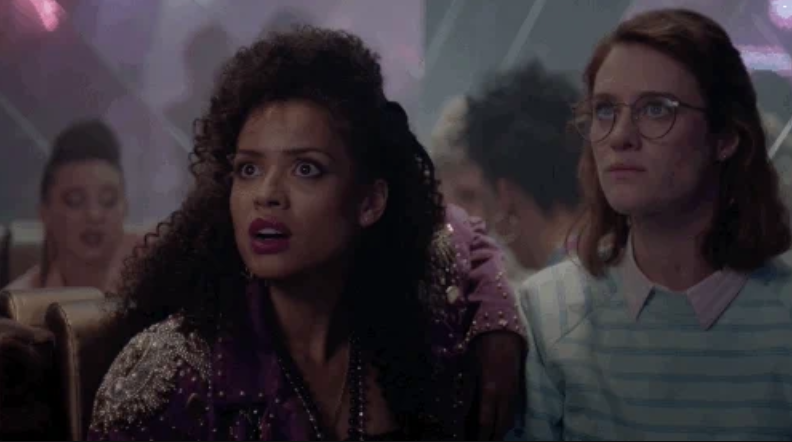 Gugu Mbatha-Raw and Mackenzie Davis in a scene from Black Mirror, with Mbatha-Raw appearing surprised and Davis looking concerned