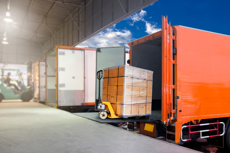 Pallet Stacker Loading Goods Onto Truck