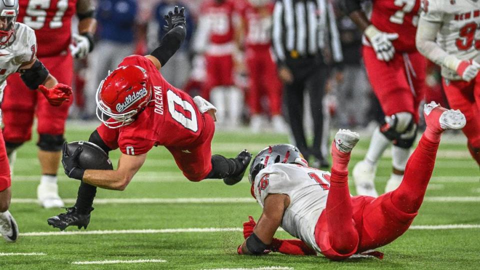 Fresno State’s Mac Dalena, left, is tripped up by New Mexico’s Dimitri Johnson in their game at Bulldog Stadium on Saturday, Nov. 18, 2023.