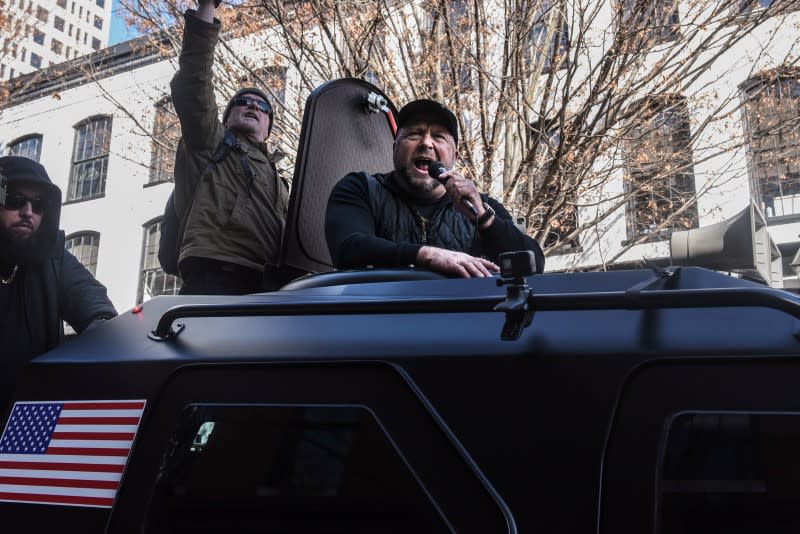 Info Wars host Alex Jones yells while riding in his Info Wars car on a Gun Lobby Day in front of the Virginia State Capitol building in Richmond, Virginia