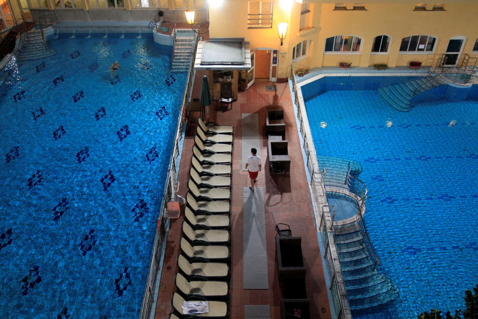 <p>A lifeguard walks along pools at the Lukacs Bath in Budapest, Hungary on July 6, 2016. (REUTERS/Bernadett Szabo) </p>