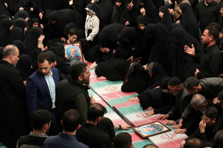 Relatives in Iran mourn over the coffins of seven Revolutionary Guard Corps members killed in a strike on the country's consular annex in Damascus, which Tehran blamed on Israel (-)