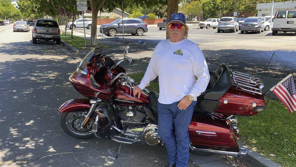 Kirk Bertolet, a train signal maintenance worker at Valley Transportation Authority, stands by his motorbike in San Jose, Calif., Thursday May 27, 2021. Bertolet was at work the morning before when a gunman fatally shot nine of his co-workers before killing himself. Bertolet said he was next door to the room where several of his colleagues were gunned down. After the gunman left, he tried to help his colleagues, but it was too late. (AP Photo/Terry Chea)