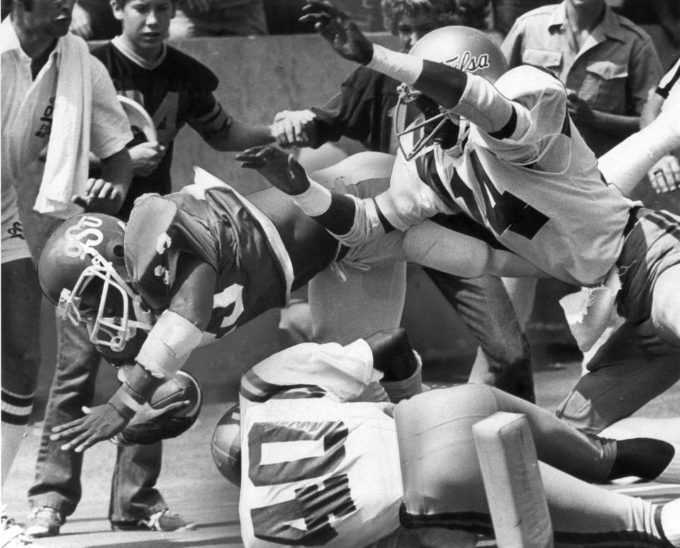 OKLAHOMA STATE UNIVERSITY, COLLEGE FOOTBALL, OSU: 9/10/1977-Terry Miller dives for some of his 189 yards against Tulsa. Miller finished second in the voting for the 1977 Heisman trophy.