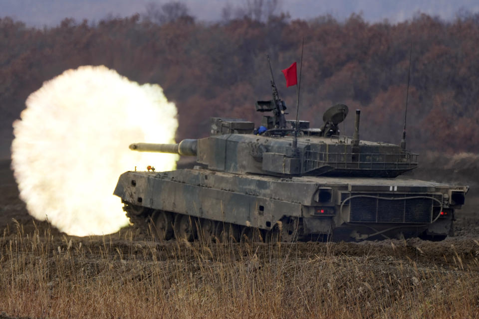 Japanese Ground-Self Defense Force (JGDDF) Type 90 tank fires at a target during an annual exercise at the Minami Eniwa Camp Tuesday, Dec. 7, 2021, in Eniwa, Japan's northern island of Hokkaido. Dozens of tanks are rolling over the next two weeks on Hokkaido, a main military stronghold for a country with perhaps the world's most little known yet powerful army. (AP Photo/Eugene Hoshiko)