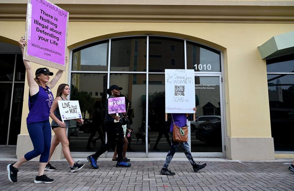 Supporters of Ashley Benefield march in downtown Bradenton ahead of her trial scheduled for July 22. Benefield is charged with second-degree murder for allegedly shooting her estranged husband in Sept. 2020.