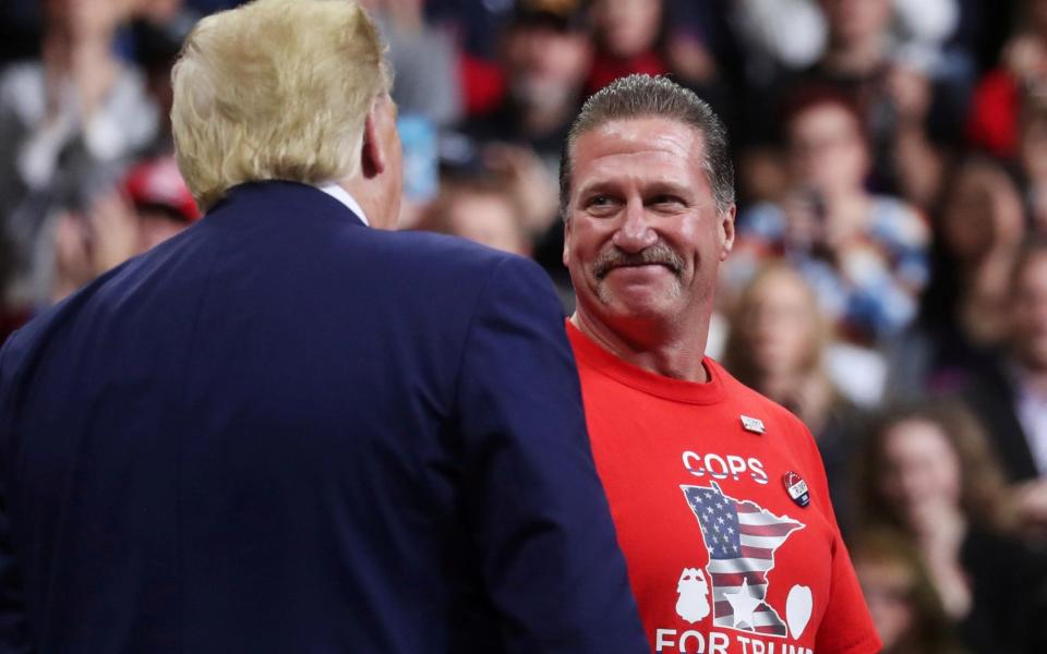 President Donald Trump greets Bob Kroll, president of the Minneapolis police union, during a campaign rally in the city in October 2019 - Leah Mills/Reuters