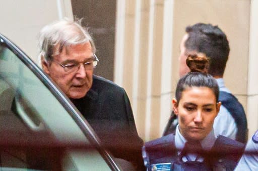 Australian Cardinal George Pell is escorted into the Supreme Court of Victoria in Melbourne at the start of his appeal process