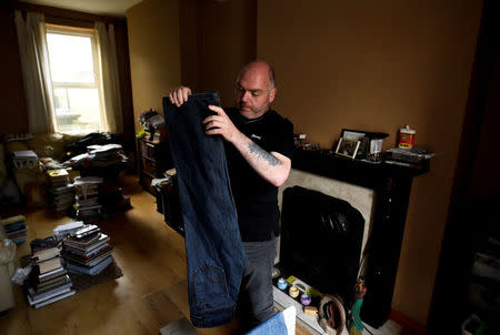 Trevor Temple hangs his laundry at his home in the walled-off loyalist Protestant enclave called The Fountain situated within the city of Londonderry, Northern Ireland, September 14, 2017. REUTERS/Clodagh Kilcoyne