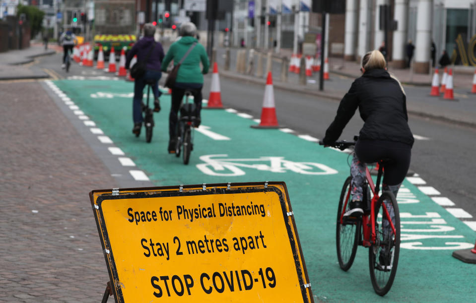 Cyclist pass social distancing signage in Glasgow as Scotland is moving into phase one of the Scottish Government's plan for gradually lifting lockdown.