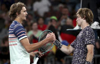 Germany's Alexander Zverev, left, is congratulated by Russia's Andrey Rublev after winning their fourth round singles match at the Australian Open tennis championship in Melbourne, Australia, Monday, Jan. 27, 2020. (AP Photo/Dita Alangkara)