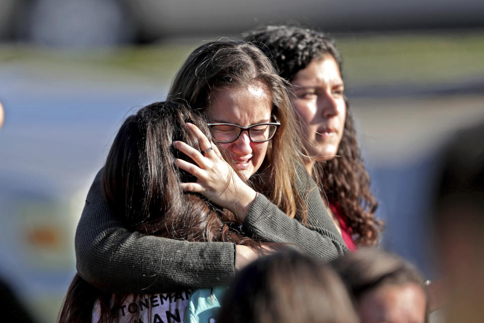 <p>Students released from a lockdown embrace following following a shooting at Marjory Stoneman Douglas High School in Parkland, Fla., Feb. 14, 2018. (Photo: John McCall/South Florida Sun-Sentinel via AP) </p>