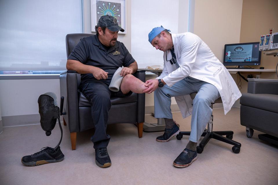 Dr. Jason Souza, a plastic surgeon and director of the Ohio State University Wexner Medical Center's Military Medicine Program, with his patient Shane Jernigan, a veteran.