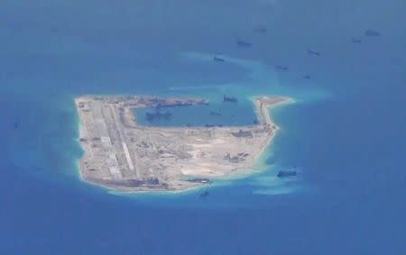 Chinese dredging vessels are purportedly seen in the waters around Fiery Cross Reef in the disputed Spratly Islands in this still image from video taken by a P-8A Poseidon surveillance aircraft provided by the United States Navy May 21, 2015. REUTERS/U.S. Navy/Handout via Reuters/Files