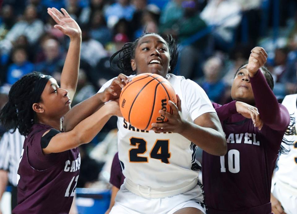 Sanford's Dallas Pierce (24) tries to get the basket against Caravel's Jasiyah Crawford (left) and Laila Glover in the first half of a DIAA state tournament semifinal, Wednesday, March 8, 2023 at the Bob Carpenter Center.