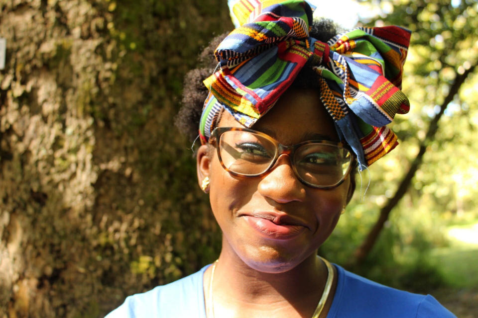 In this Sept. 30, 2020, photo provided by Victoria Ujunwa, Miracle Okoro poses on the University of North Carolina Asheville campus in Asheville, N.C. Some classes are being held in person at the university, but on many days the campus looks like a ghost town, said Okoro. “It’s not easy to be able to thrive in this environment where it’s your first year in college, your first experience in the real world and having to do it in such an isolating way,‘’ she said. (Victoria Ujunwa via AP)