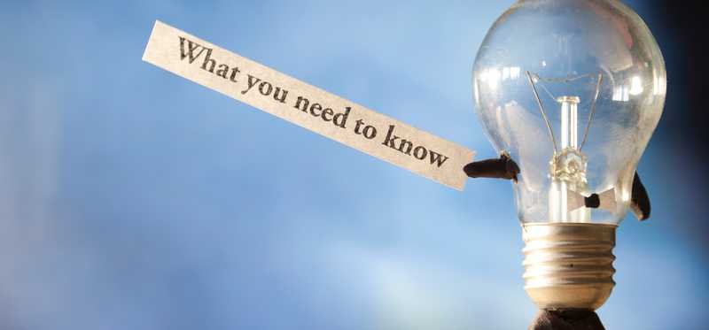 The words what you need to know held up by a lightbulb.