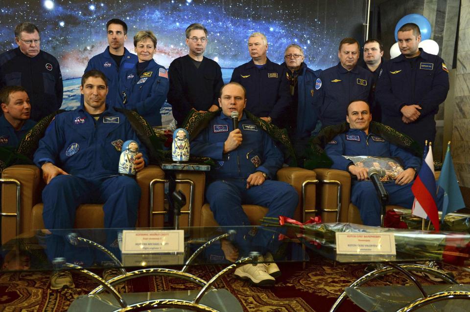 Former ISS commander Oleg Kotov (front C) and flight engineers Sergei Ryazansky (front R) of Russia and Michael Hopkins (front L) from the U.S. attend a news conference in Karaganda, March 11, 2014. An American astronaut and two Russians who carried a Sochi Olympic torch into open space landed safely and on time on Tuesday in Kazakhstan, defying bad weather and ending their 166-day mission aboard the International Space Station (ISS). Inside the capsule were former ISS commander Oleg Kotov and flight engineers Sergei Ryazansky and Michael Hopkins from NASA. The trio launched together into space on September 25. REUTERS/Vasily Maximov/Pool (KAZAKHSTAN - Tags: TRANSPORT SCIENCE TECHNOLOGY)