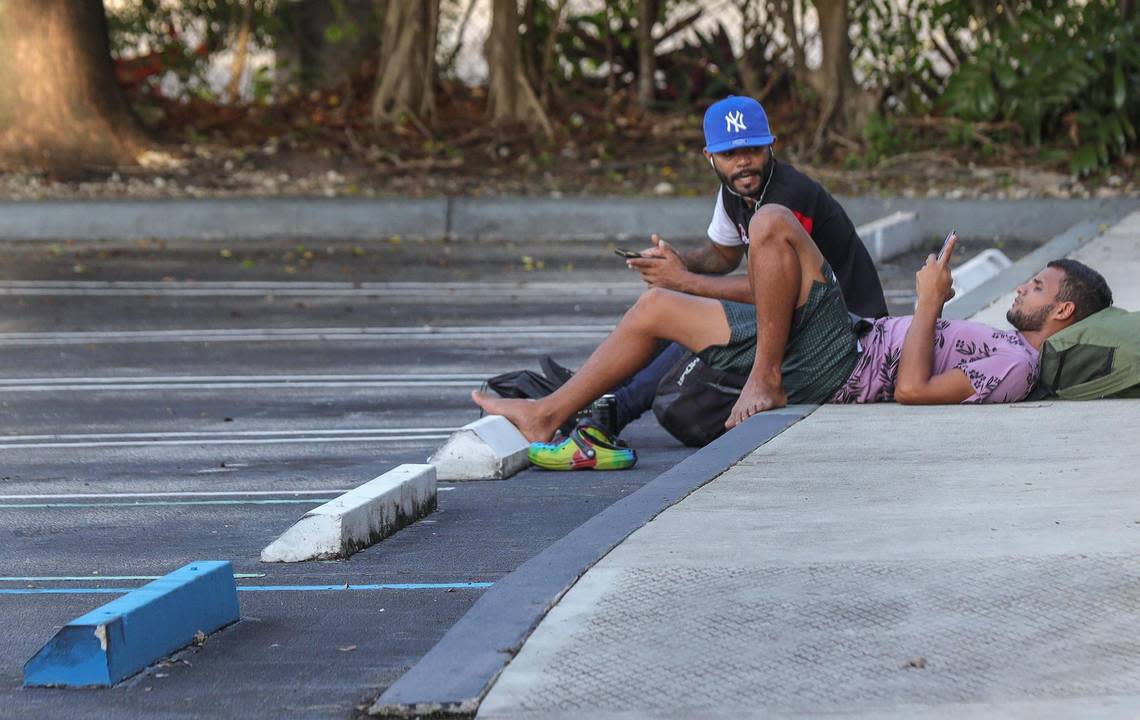 Franklin Pereira, 27, right, and a fellow Venezuelan migrant recruited from a shelter in New York to work on Hurricane Ian clean up in Fort Myers, were out in the street after being fired by Oceanside Labor and Demolition.