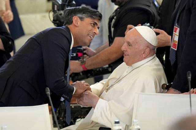 Rishi Sunak shakes hands with Pope Francis at the G7 in Puglia, Italy