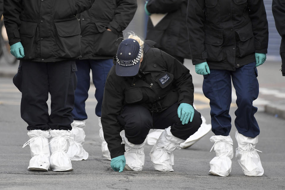 Police officers work at the scene of Sunday's terror stabbing attack in the Streatham area of south London Monday Feb. 3, 2020. Police in London say the man identified as 20-year-old Sudesh Amman was wearing a fake bomb and stabbed two people Sunday before being shot to death by police was recently released from prison, where he was serving for terrorism offenses. (AP Photo/Alberto Pezzali)