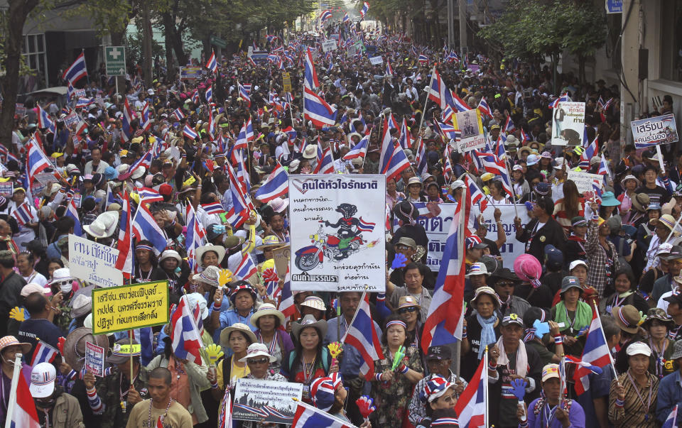 Anti-government protesters march during a rally Friday, Jan. 17, 2014, in Bangkok, Thailand. Thailand's prime minister was facing fresh legal troubles Friday after the country's anti-corruption commission announced it would investigate her handling of a controversial rice policy. (AP Photo/Sakchai Lalit)